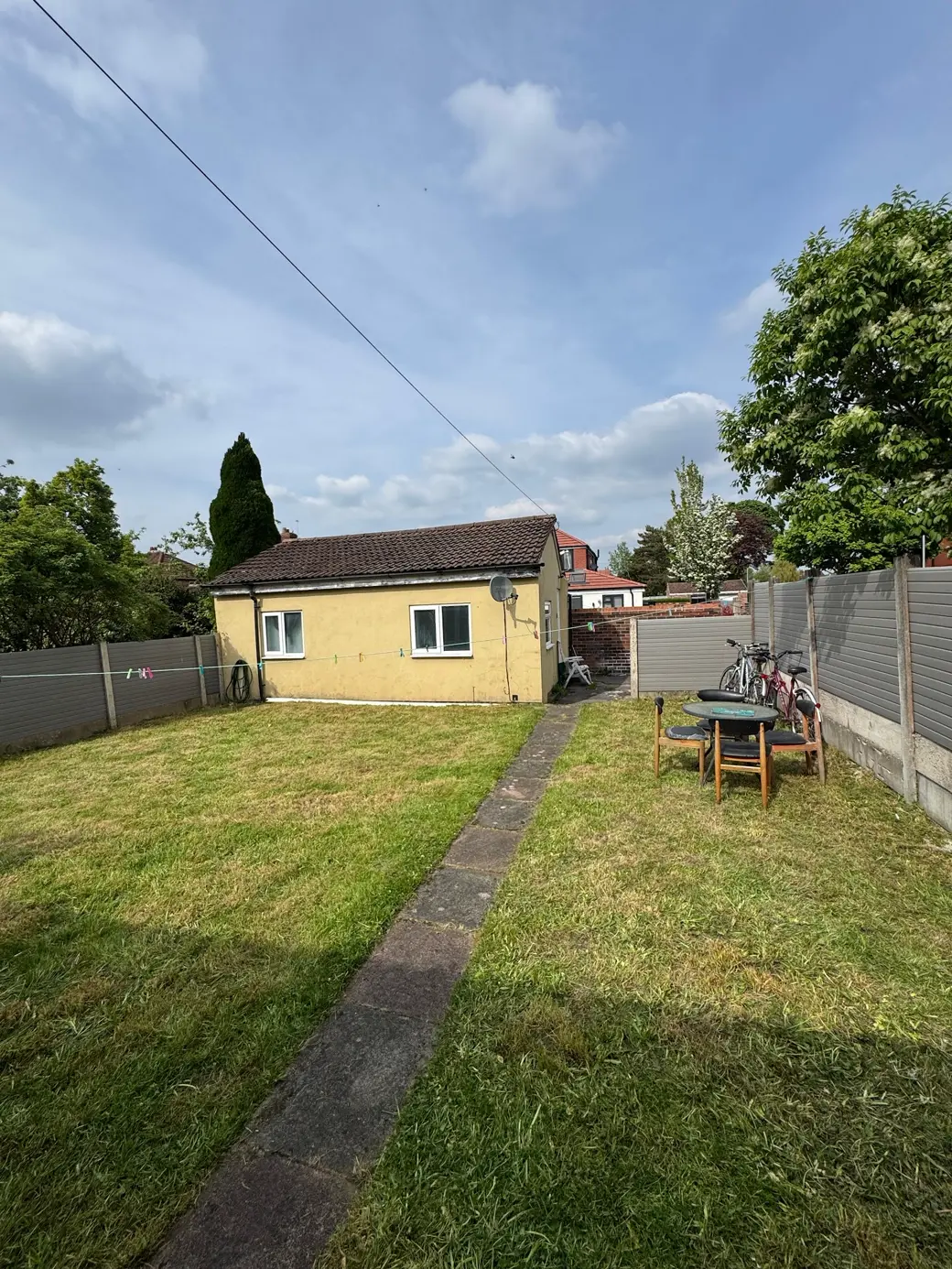 After — the same garden cleared and freshly mown to a neat, healthy lawn by Manchester Green Glow